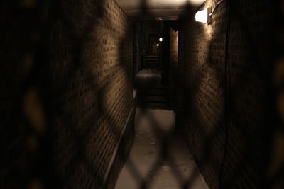 Illuminated underground walkway at night