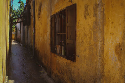 Empty alley amidst buildings in city