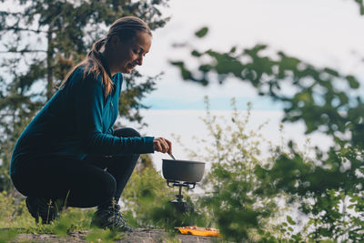 Woman cooking food on stove