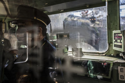Man working on car window