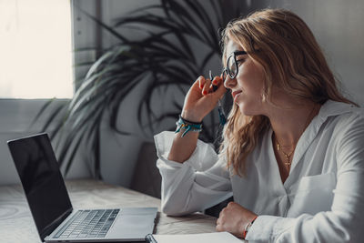 Young woman using laptop at office