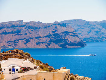 Scenic view of sea and mountains against sky