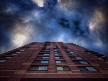 Low angle view of modern building against cloudy sky