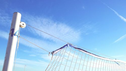 Low angle view of volleyball net against blue sky