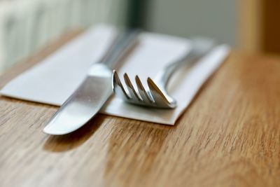 Close-up of spoon and knife on table at home