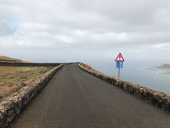 View of road sign against sky