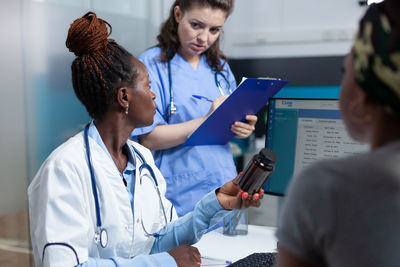 Side view of doctor examining patient at clinic