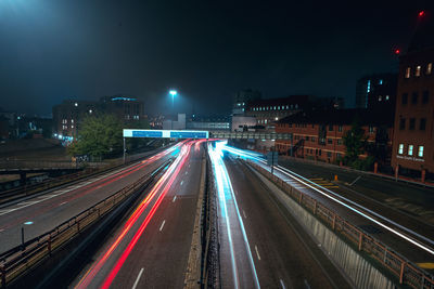 High angle view of light trails on road at night