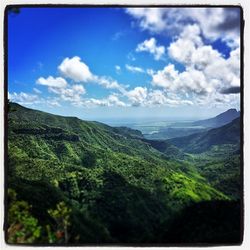 Scenic view of mountains against cloudy sky