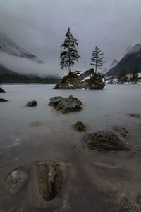 Scenic view of lake against sky during winter