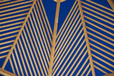 Low angle view of parasol against blue sky