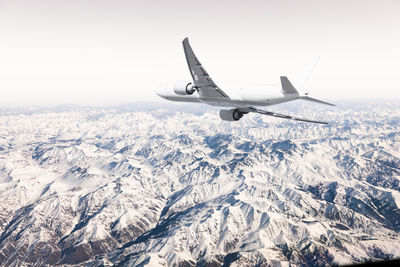 Low angle view of airplane flying against sky