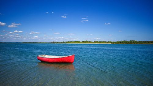 Boat in sea against blue sky