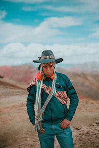 Portrait of man standing on land against sky