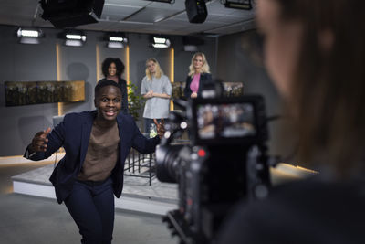 Tv show host and guests in studio