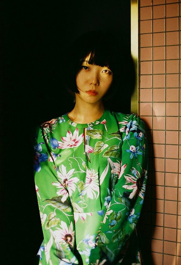 one person, real people, standing, front view, lifestyles, young adult, indoors, leisure activity, waist up, green color, casual clothing, looking, three quarter length, women, floral pattern, young women, clothing, kimono, hairstyle, beautiful woman, contemplation
