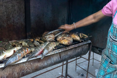 Man preparing food on barbecue grill