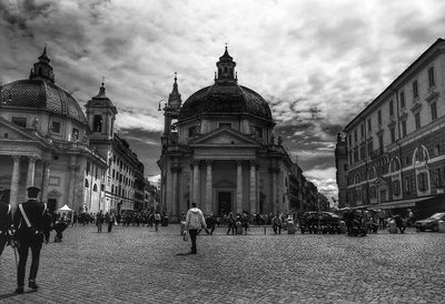 Tourists against cloudy sky