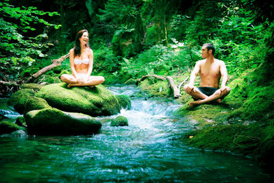 Young woman sitting in a forest
