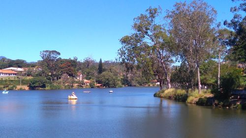 Scenic view of lake against clear blue sky