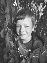 Portrait of happy boy with leaves