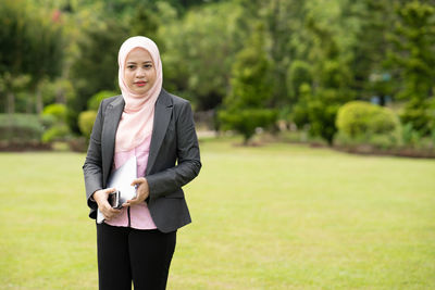 Portrait of a smiling young woman standing outdoors