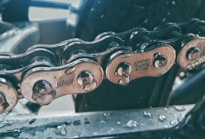 Close-up of water drops on metallic bicycle chain
