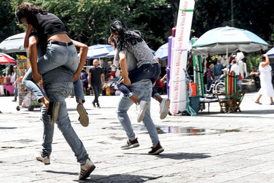 People walking on street in city