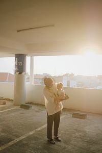 Full length rear view of woman standing against sky