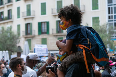 Side view of people on street in city