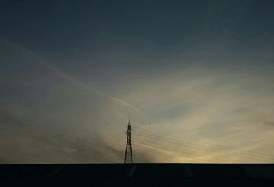 Low angle view of power lines against sky