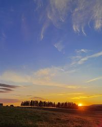 Scenic view of sunset over land