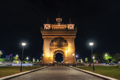 Illuminated building against sky at night