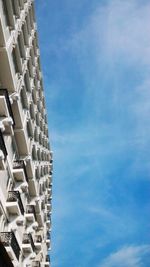 Low angle view of modern building against blue sky