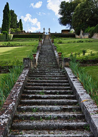 Walkway on field against sky