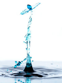 Close-up of water splashing against white background