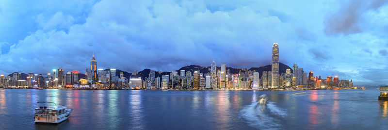 View of cityscape against cloudy sky