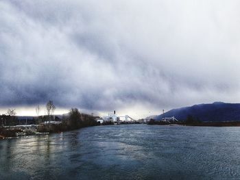 Scenic view of lake against sky during winter