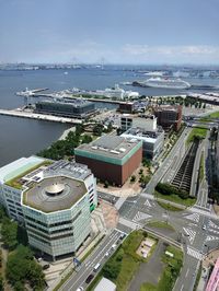 High angle view of cityscape by sea against sky