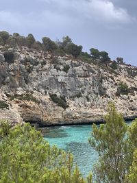Rock formations by sea against sky