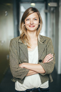 Portrait of businesswoman smiling while standing in office