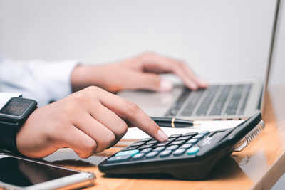 Midsection of man using laptop on table