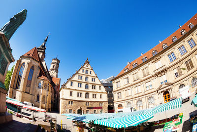 Low angle view of buildings against blue sky