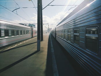 Trains at railroad station against sky