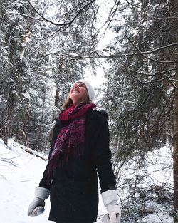 Woman standing on snow covered land