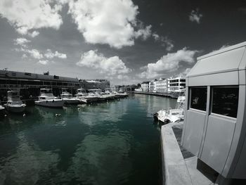 Boats moored in calm sea against sky