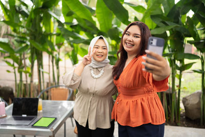 Portrait of young woman using mobile phone