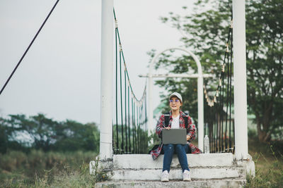 Full length of young woman standing in park