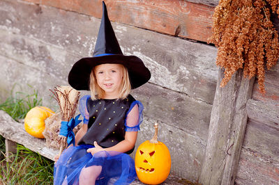 Portrait of smiling young woman with pumpkin