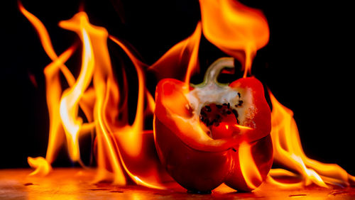 Close-up of burning candle on table